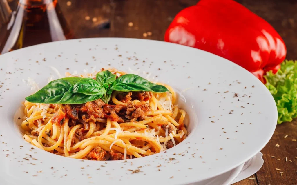 Spaghetti Bolognese with tomato meat sauce and fresh basil