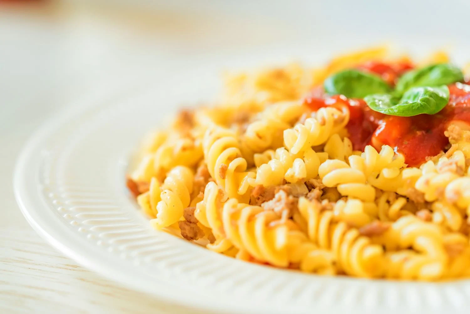 Fusilli pasta with tomato sauce and fresh basil