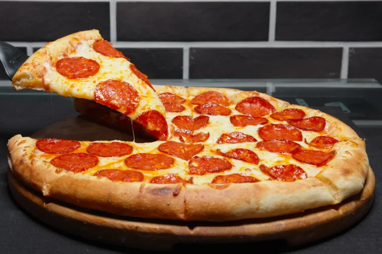 Pepperoni pizza with a lifted slice and melted cheese